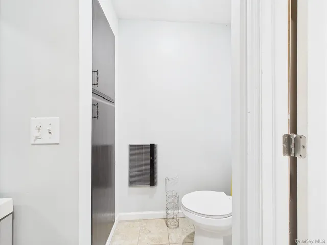 a white toilet sitting next to a shower