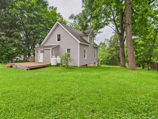 a view of backyard of house with green space