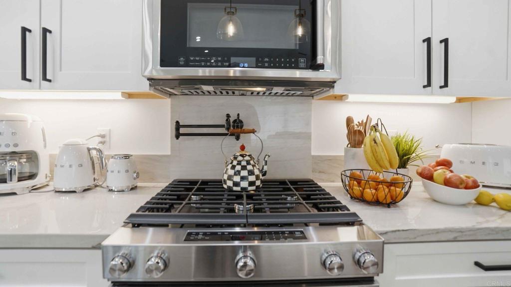 9391 Los Coches Road Lakeside, CA 92040 - Photo 21 of 65 a kitchen with a stove and cabinets
