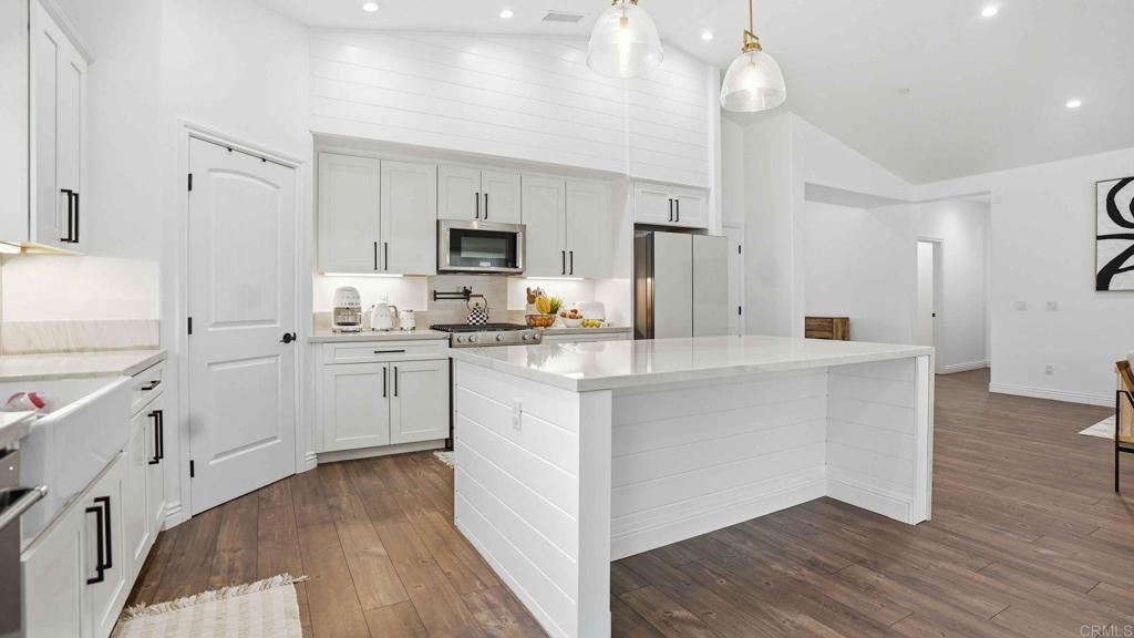 9391 Los Coches Road Lakeside, CA 92040 - Photo 22 of 65 a kitchen with white cabinets and stainless steel appliances