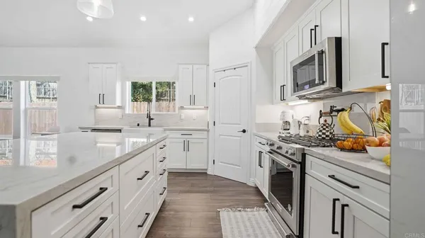 a large bed sitting in a bedroom next to a cabinet