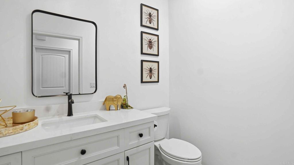 9391 Los Coches Road Lakeside, CA 92040 - Photo 24 of 65 a bathroom with a toilet sink vanity and mirror