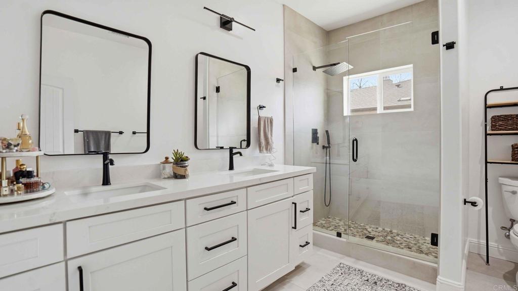 9391 Los Coches Road Lakeside, CA 92040 - Photo 32 of 65 a bathroom with a double vanity sink mirror double shower and a mirror