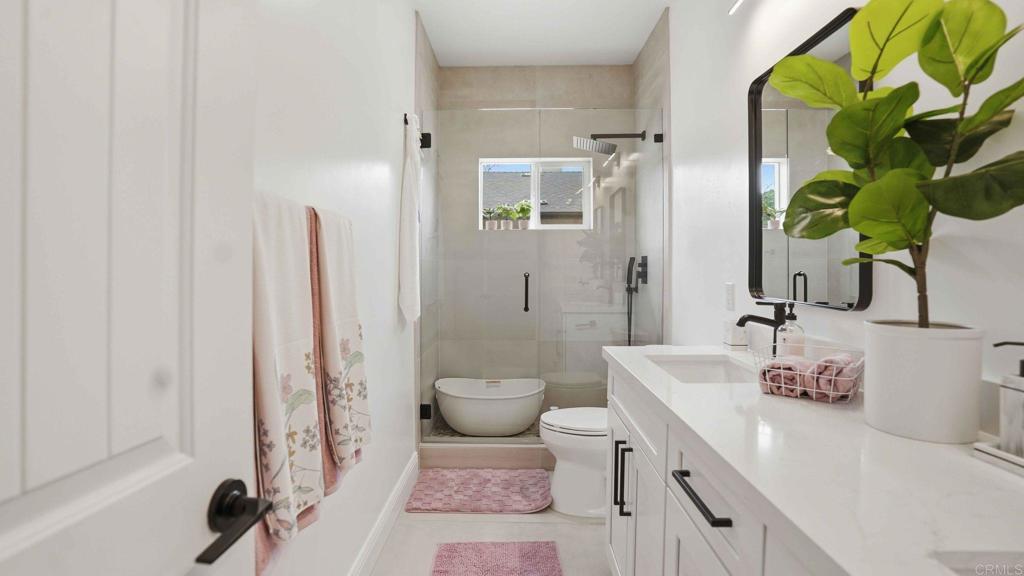 9391 Los Coches Road Lakeside, CA 92040 - Photo 35 of 65 a bathroom with a granite countertop sink a toilet and a shower
