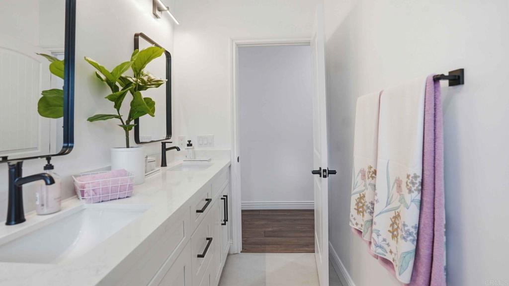 9391 Los Coches Road Lakeside, CA 92040 - Photo 36 of 65 a bathroom with double vanity sink and a mirror