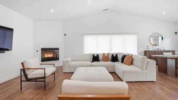 a living room with furniture a rug and a lamp