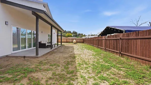 a front view of a house with a garden and yard