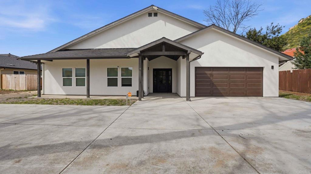 9391 Los Coches Road Lakeside, CA 92040 - Photo 56 of 65 a front view of a house with a yard and garage