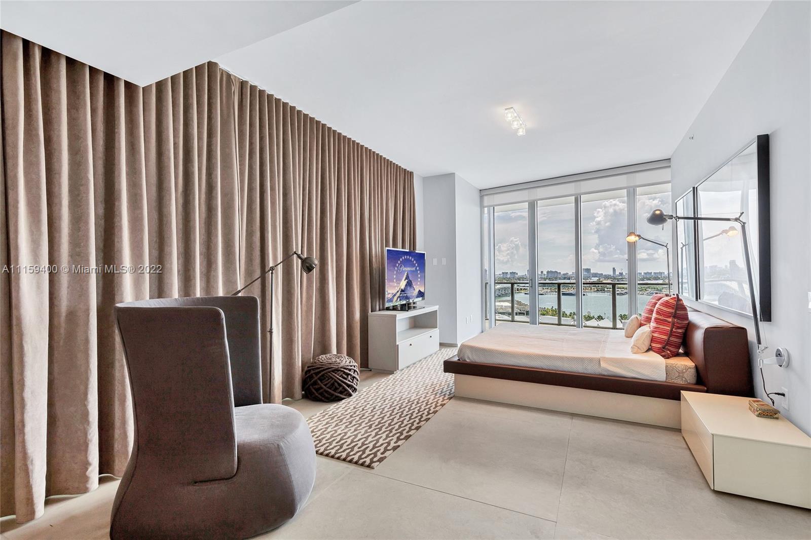 1100 Biscayne Boulevard, Unit 1801 Miami, FL 33132 - Photo 17 of 27 a living room with furniture and a large window