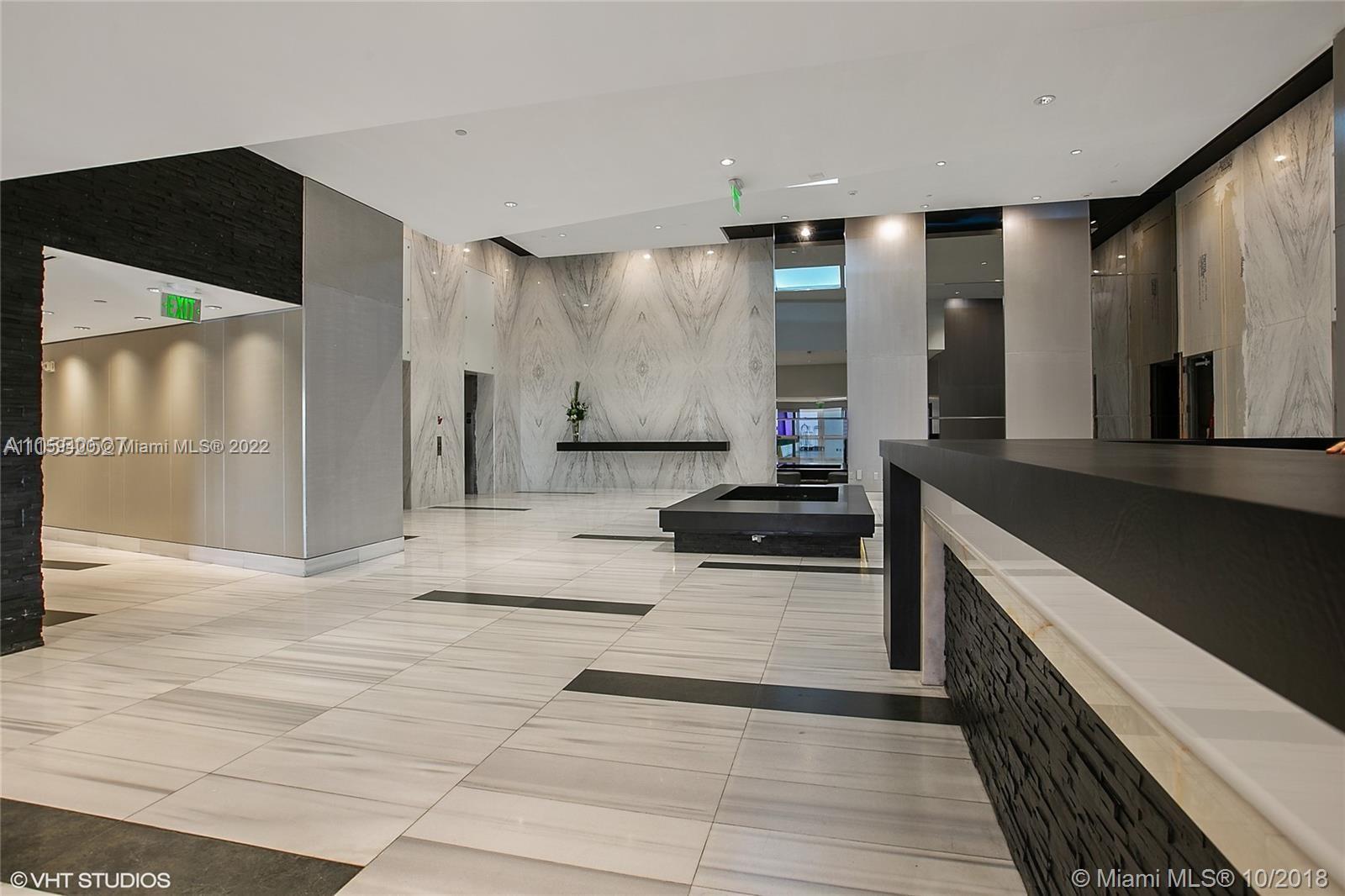 1100 Biscayne Boulevard, Unit 1801 Miami, FL 33132 - Photo 2 of 27 a large bathroom with a large mirror vanity and shower