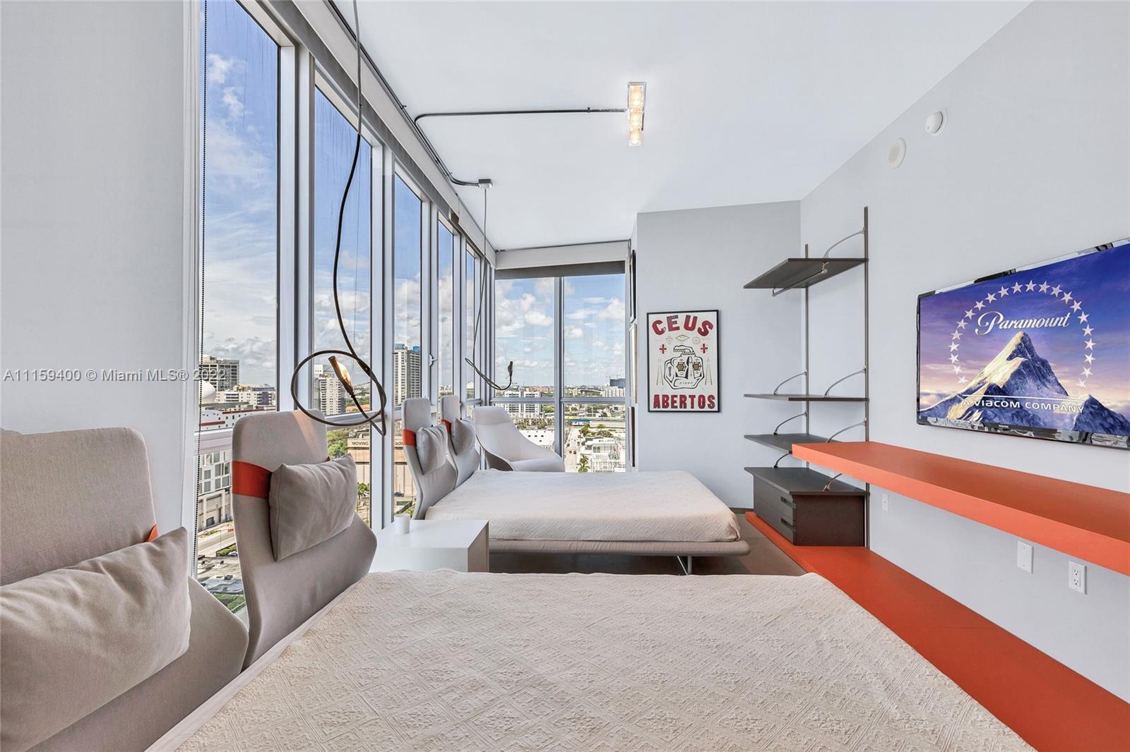 1100 Biscayne Boulevard, Unit 1801 Miami, FL 33132 - Photo 23 of 27 a bedroom with furniture and a large window