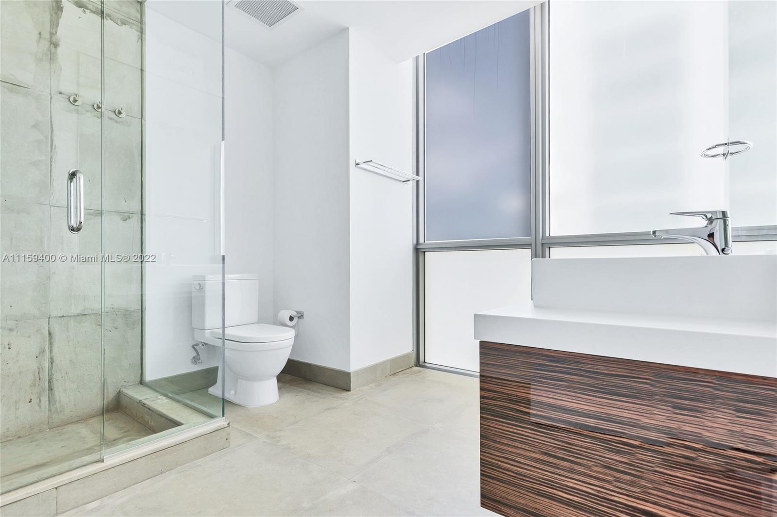 1100 Biscayne Boulevard, Unit 1801 Miami, FL 33132 - Photo 24 of 27 a bathroom with a toilet and a shower