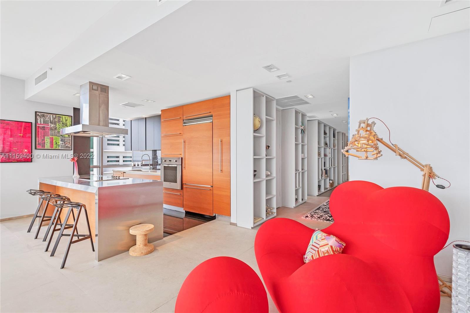 1100 Biscayne Boulevard, Unit 1801 Miami, FL 33132 - Photo 5 of 27 a bedroom with furniture and a wooden floor