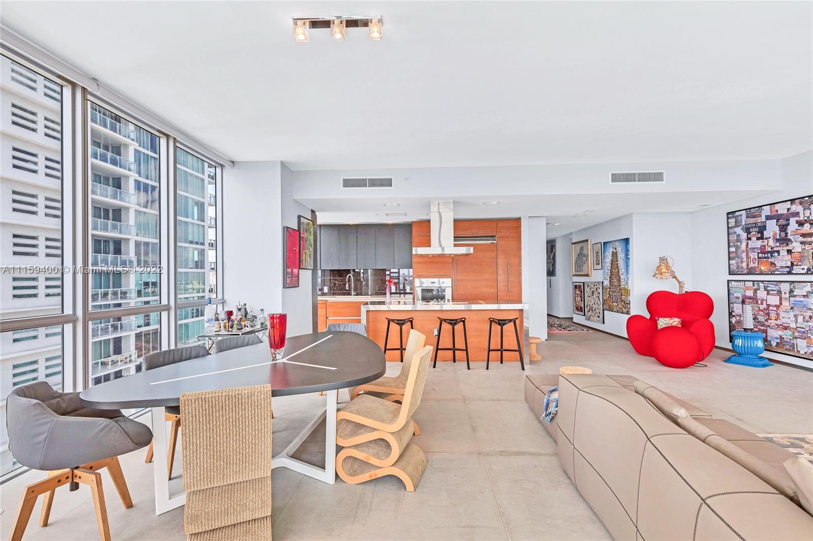 1100 Biscayne Boulevard, Unit 1801 Miami, FL 33132 - Photo 7 of 27 a outdoor space with a large window and chairs