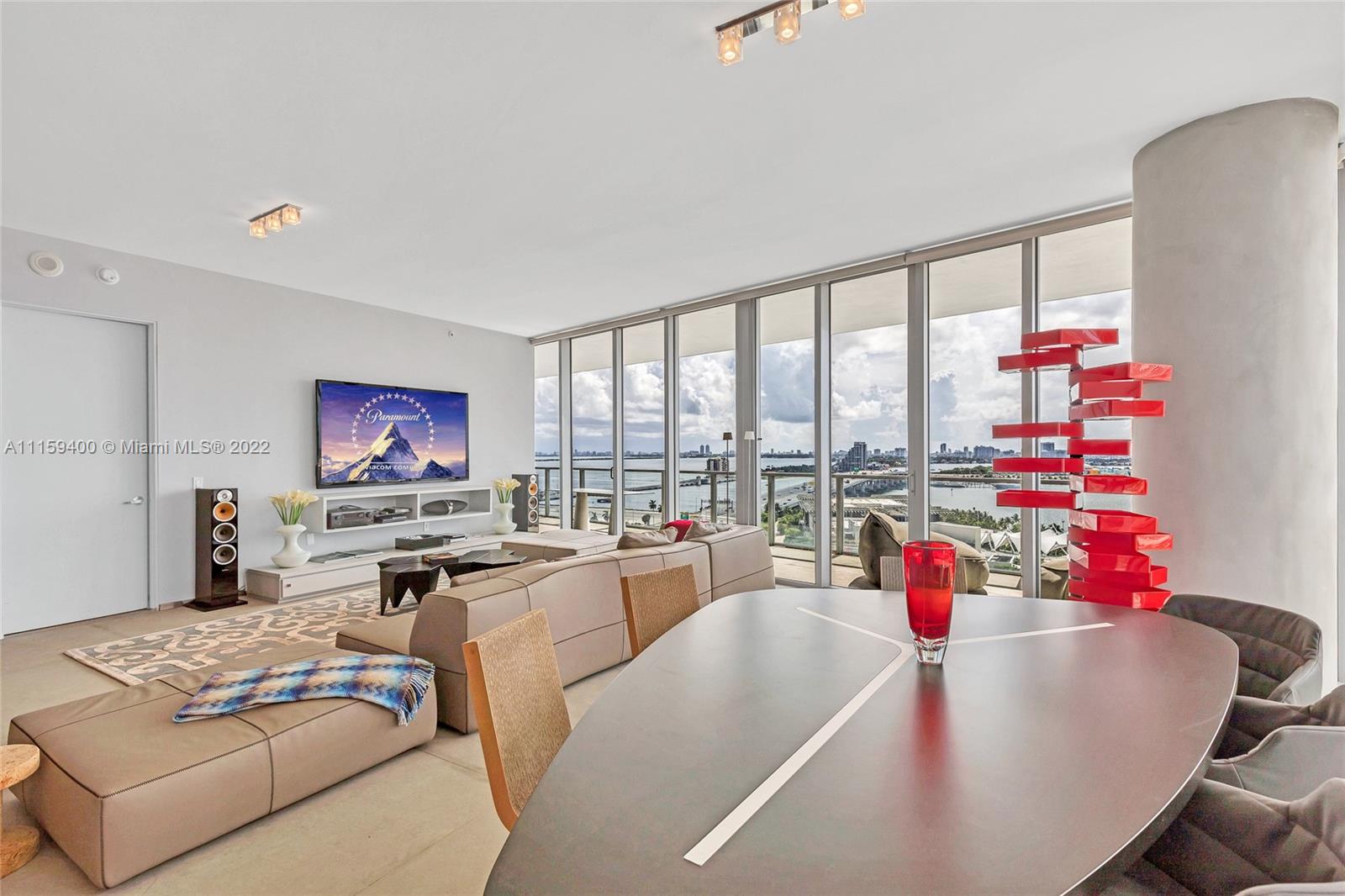 1100 Biscayne Boulevard, Unit 1801 Miami, FL 33132 - Photo 9 of 27 a living room with furniture and a floor to ceiling window