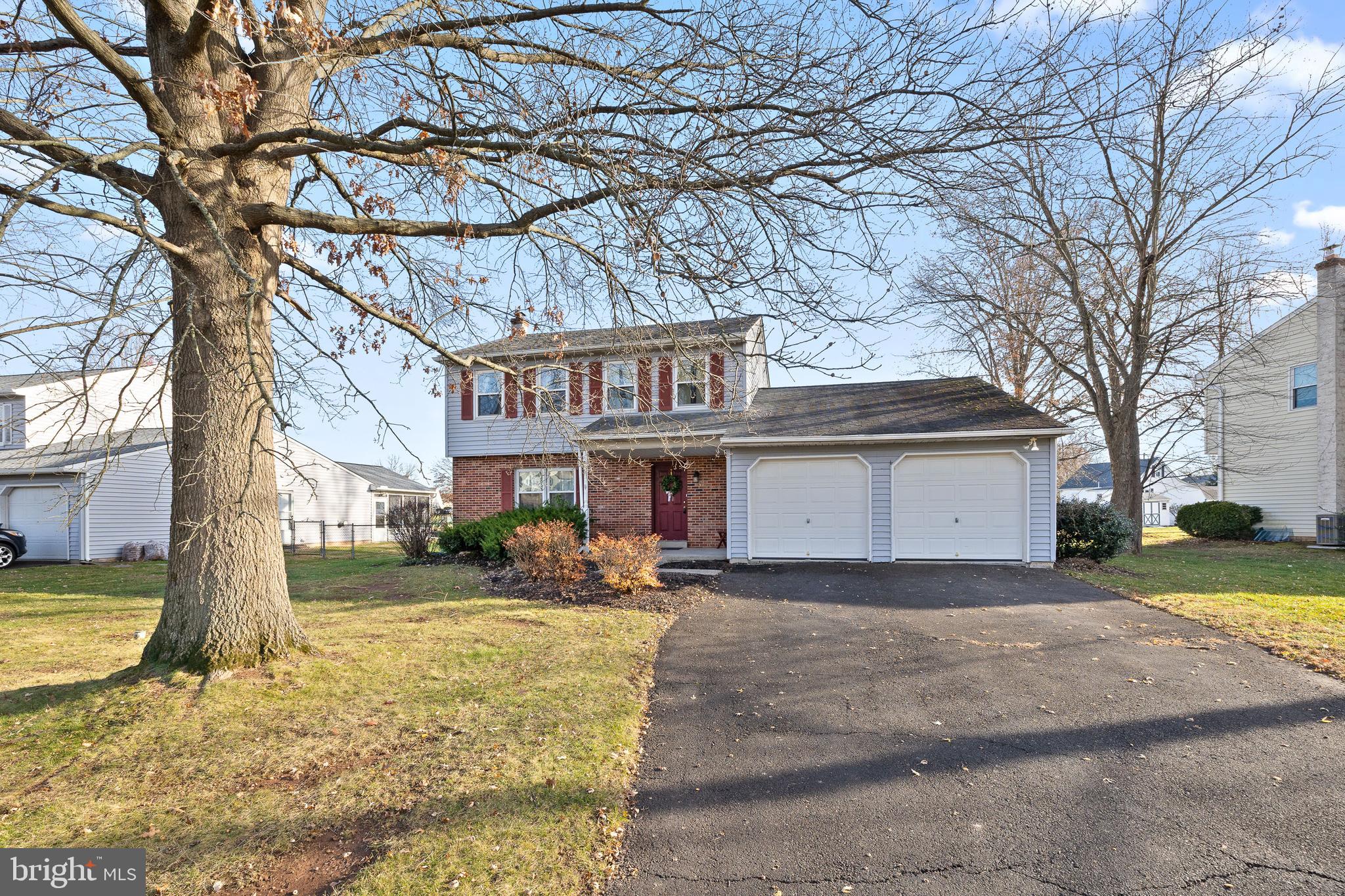 829 Alexander Drive Hatfield, PA 19440 - Photo 1 of 28 a front view of a house with a yard and large tree
