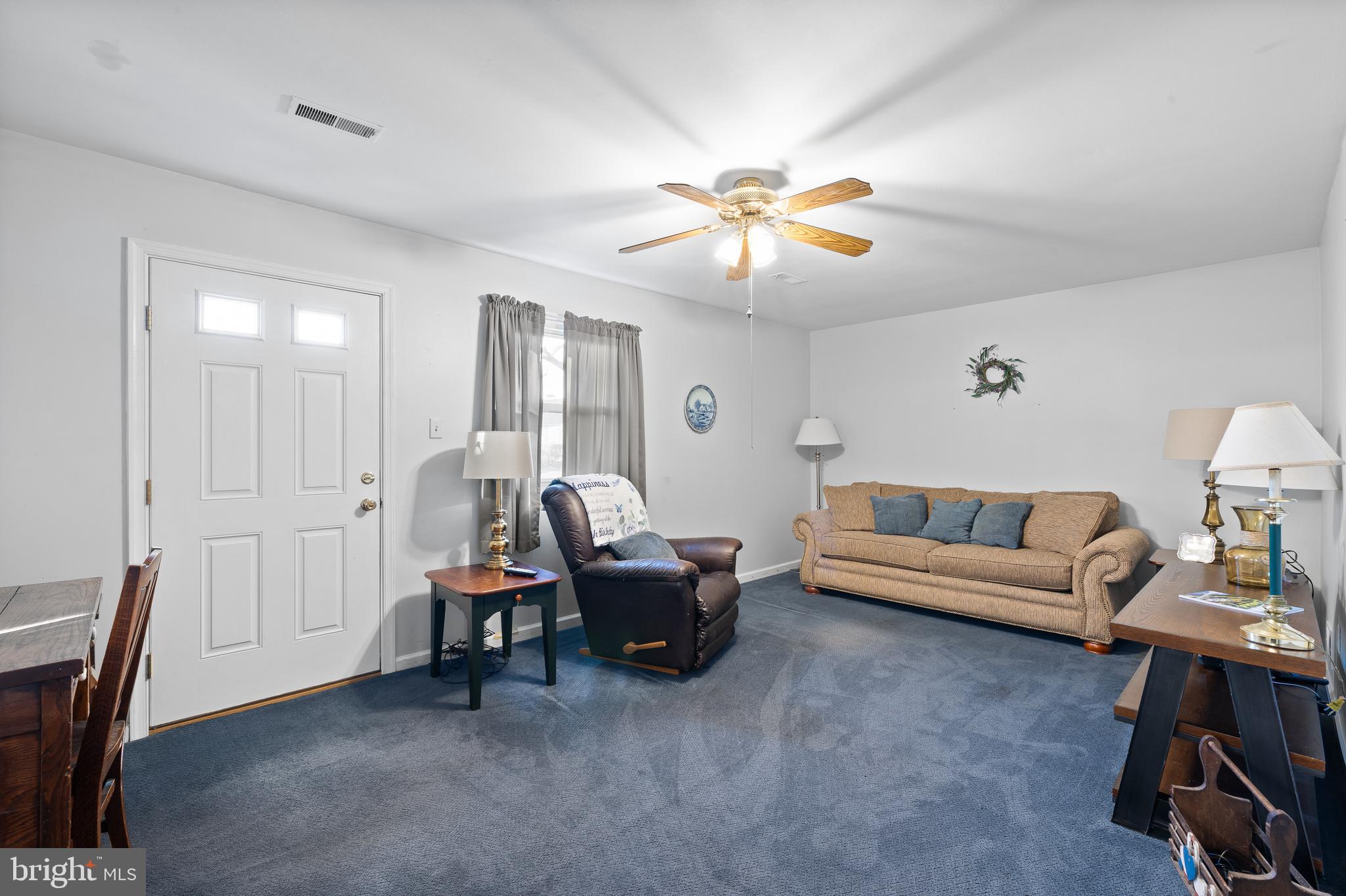 829 Alexander Drive Hatfield, PA 19440 - Photo 14 of 28 a living room with furniture a ceiling fan and a rug