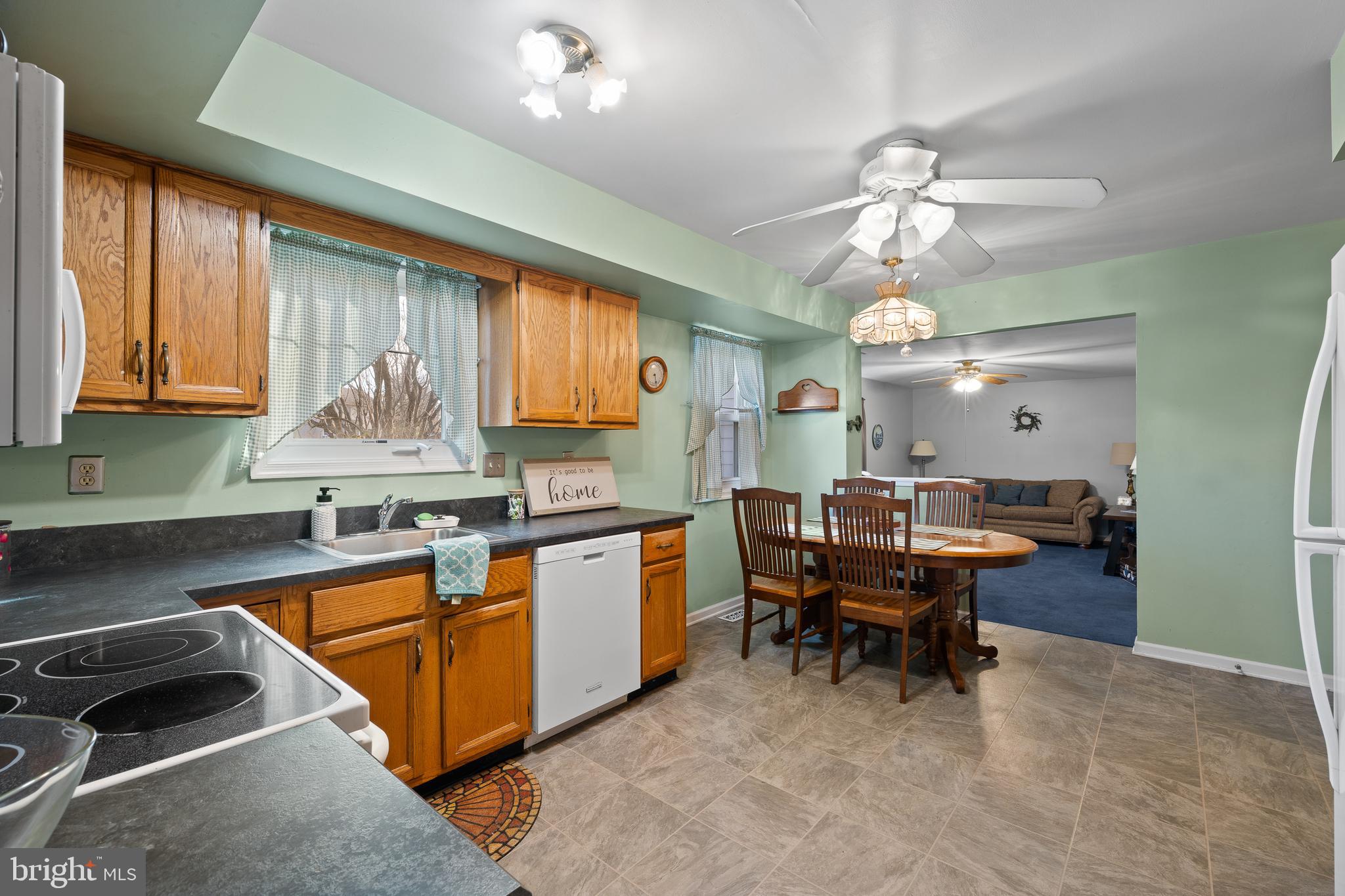829 Alexander Drive Hatfield, PA 19440 - Photo 8 of 28 a kitchen with a stove a sink a dining table and chairs