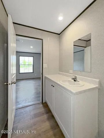 a bathroom with a sink a toilet and mirror