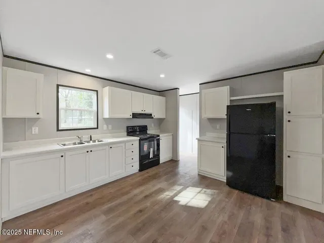 a kitchen with a refrigerator and a sink