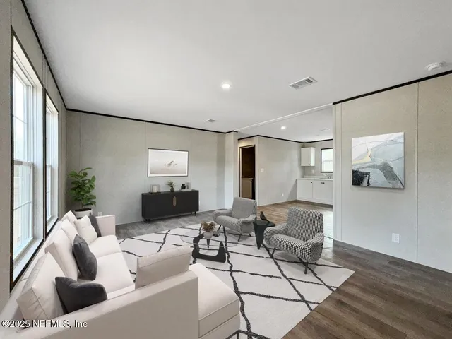 a living room with furniture and wooden floor