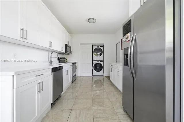 a kitchen with a refrigerator and a stove top oven