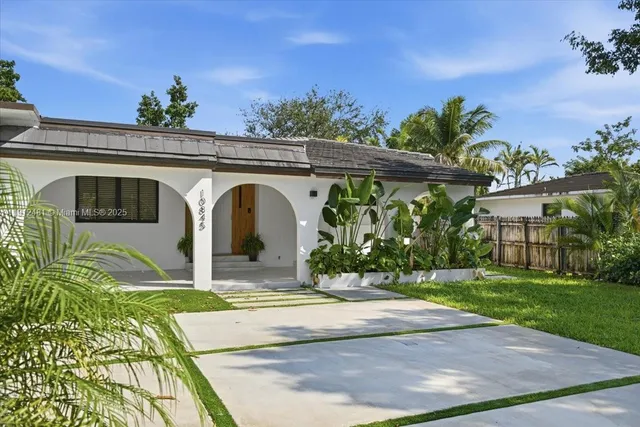 a front view of a house with garden