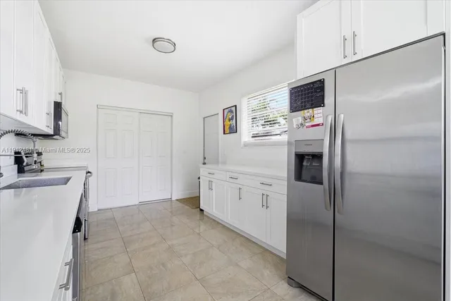 a kitchen with a refrigerator stove and sink