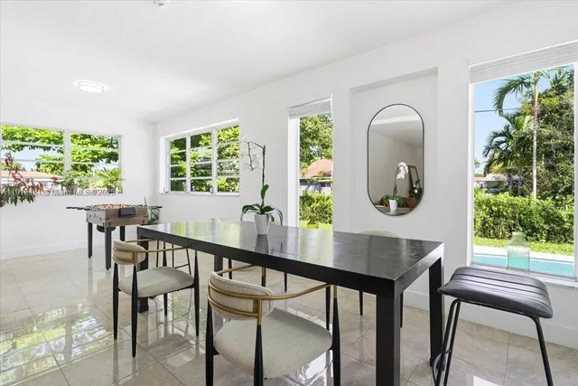 a living room with furniture a window and a chandelier