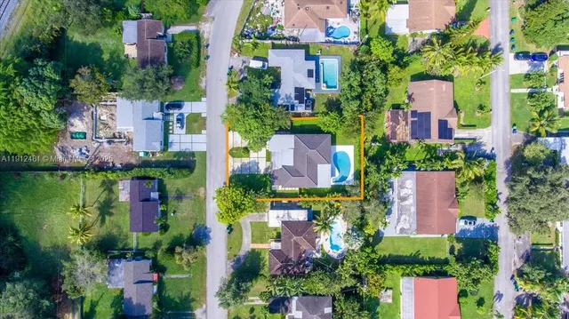 an aerial view of street and swimming pool