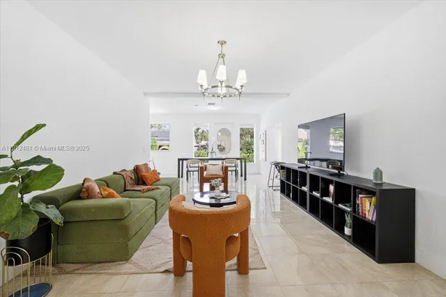 a living room with furniture and a chandelier