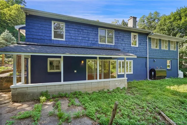 a view of a brick house with a large windows and a yard