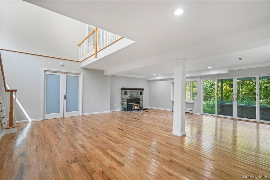448 Sprout Brook Road Garrison, NY 10524 - Photo 7 of 22 Unfurnished living room with light wood-type flooring and a baseboard radiator