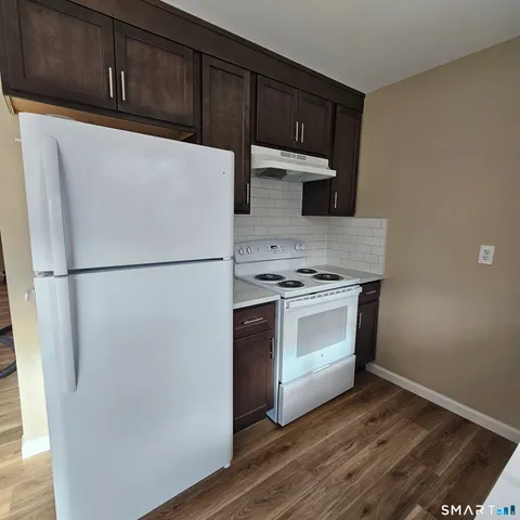 a kitchen with stainless steel appliances a refrigerator stove and cabinets