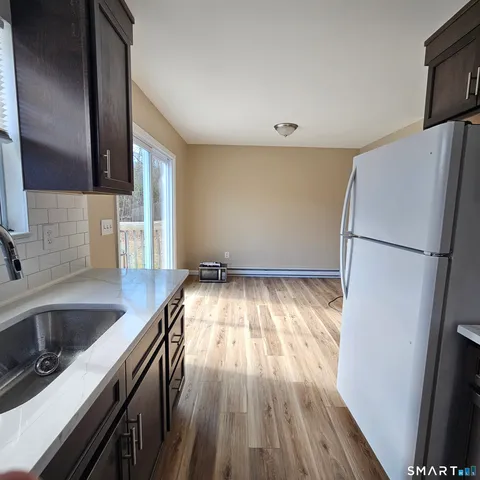 a kitchen with a refrigerator and a sink