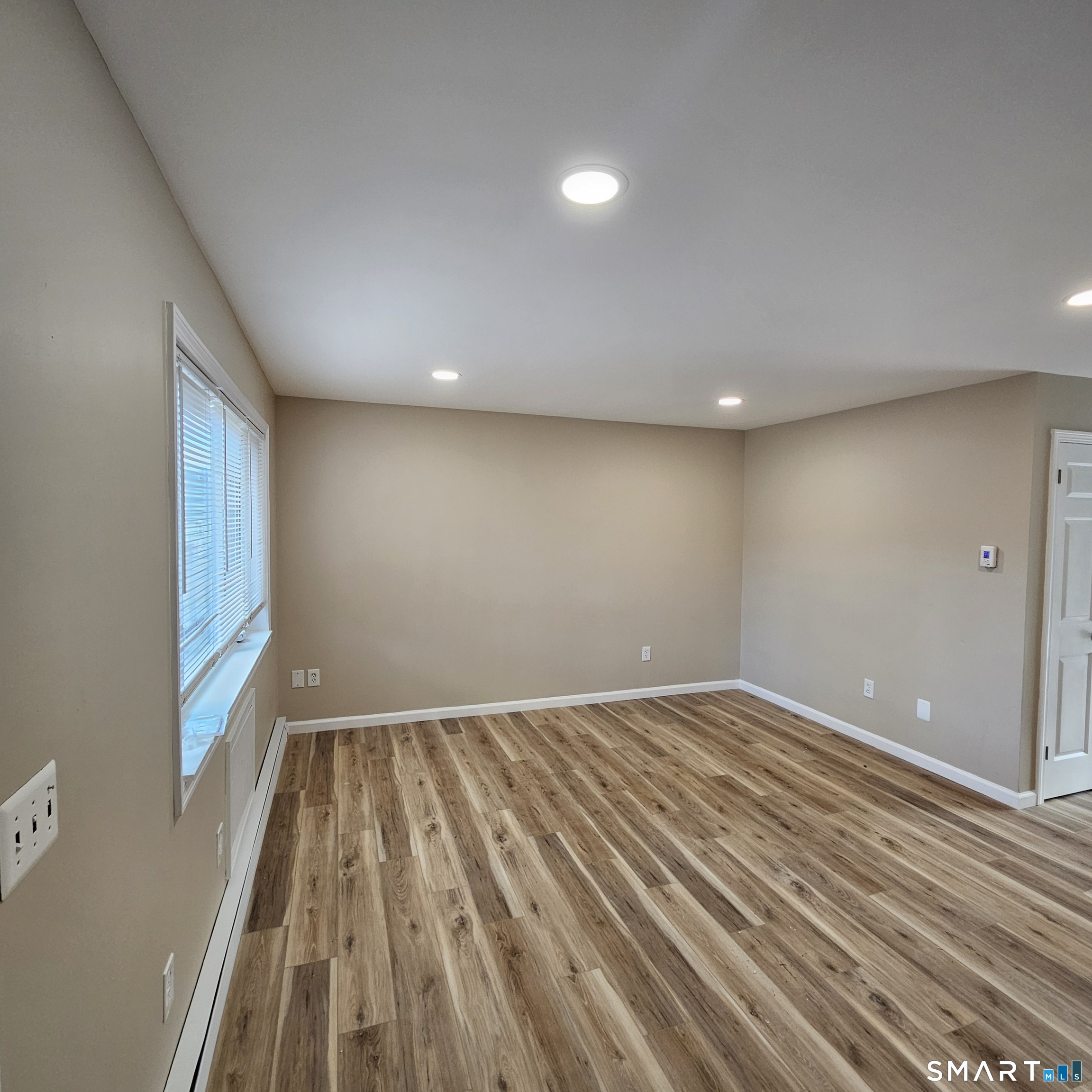 373 Wolcott Street Bristol, CT 06010 - Photo 19 of 23 wooden floor in an empty room with a window
