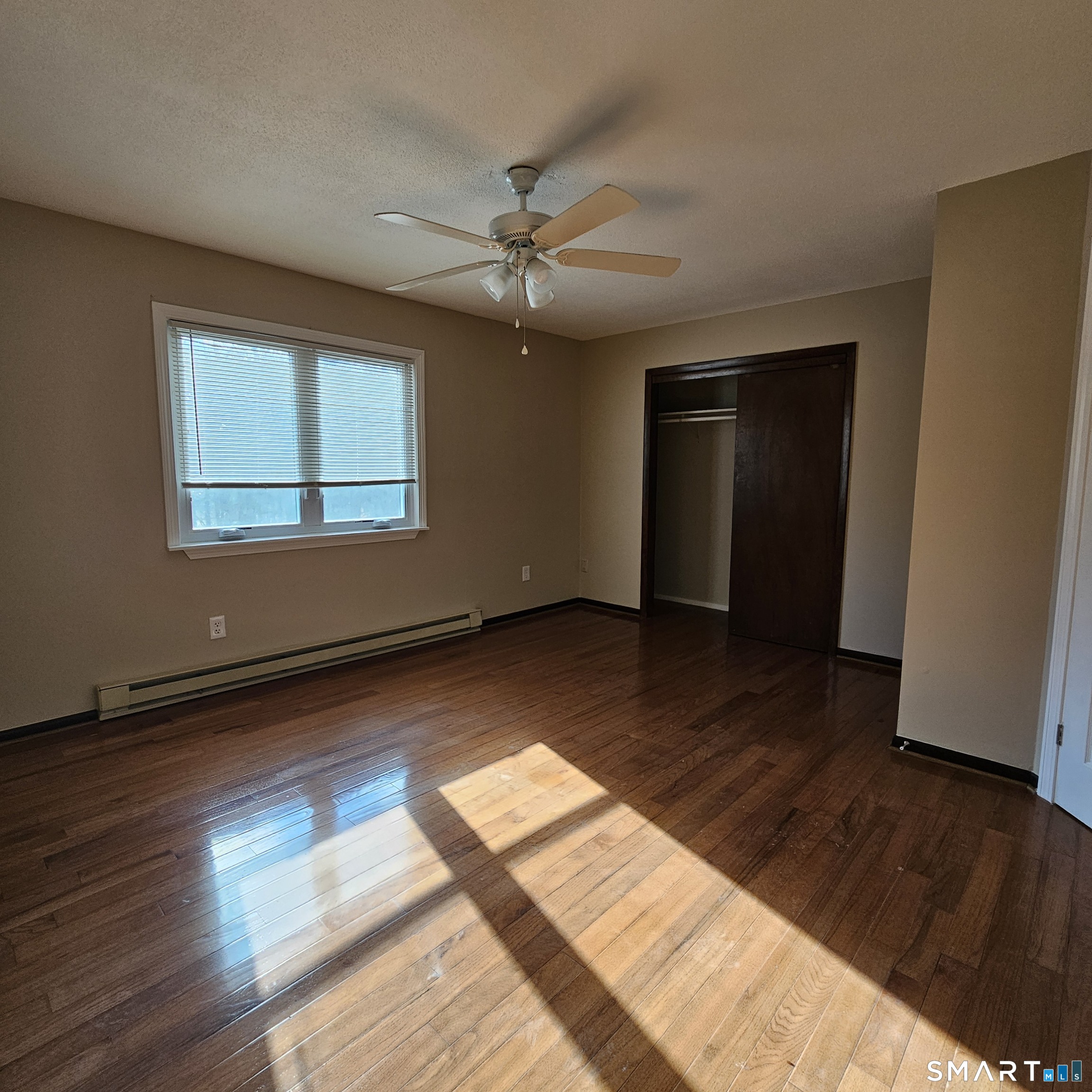 373 Wolcott Street Bristol, CT 06010 - Photo 2 of 23 a view of an empty room with wooden floor and a window