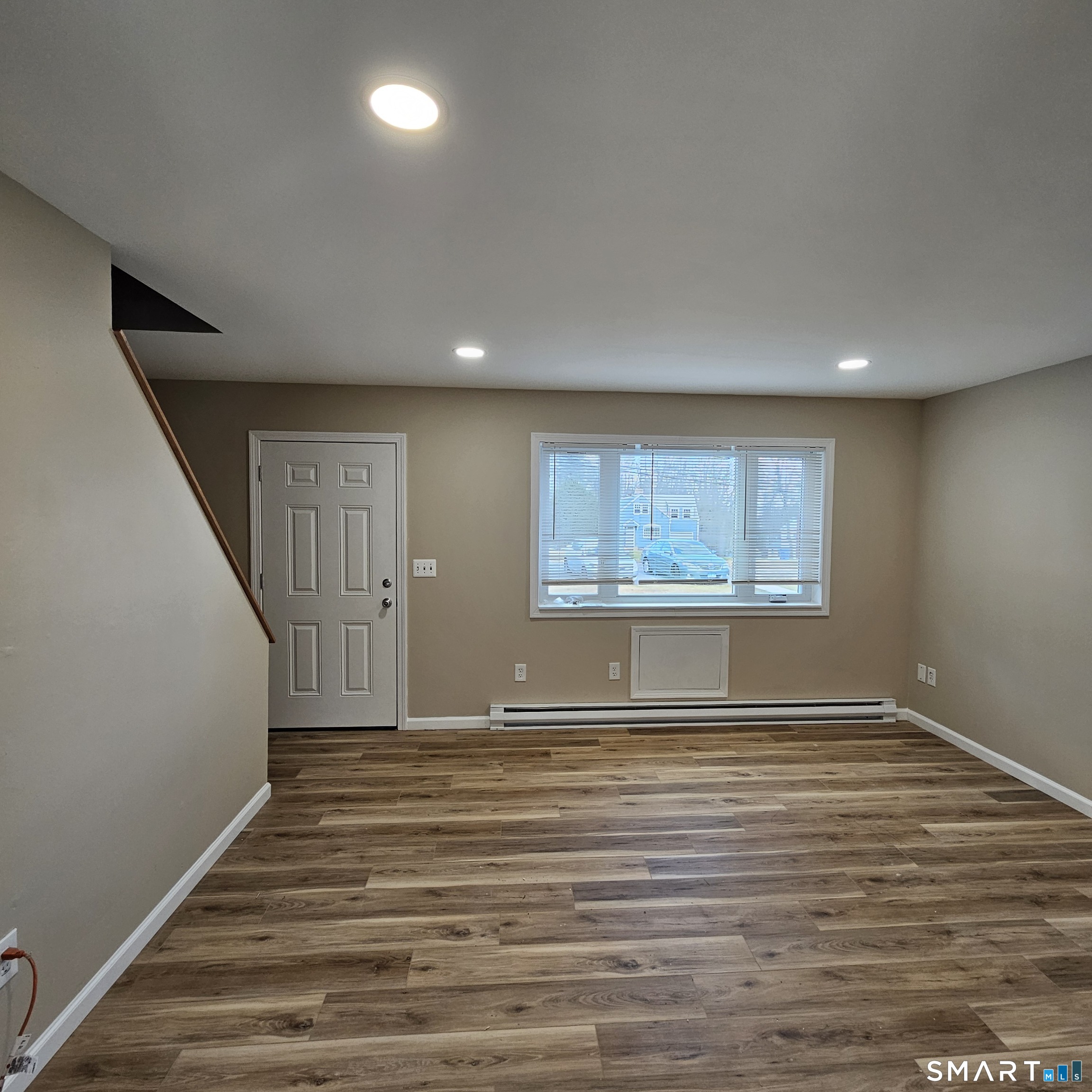 373 Wolcott Street Bristol, CT 06010 - Photo 22 of 23 a view of an empty room with wooden floor and a window