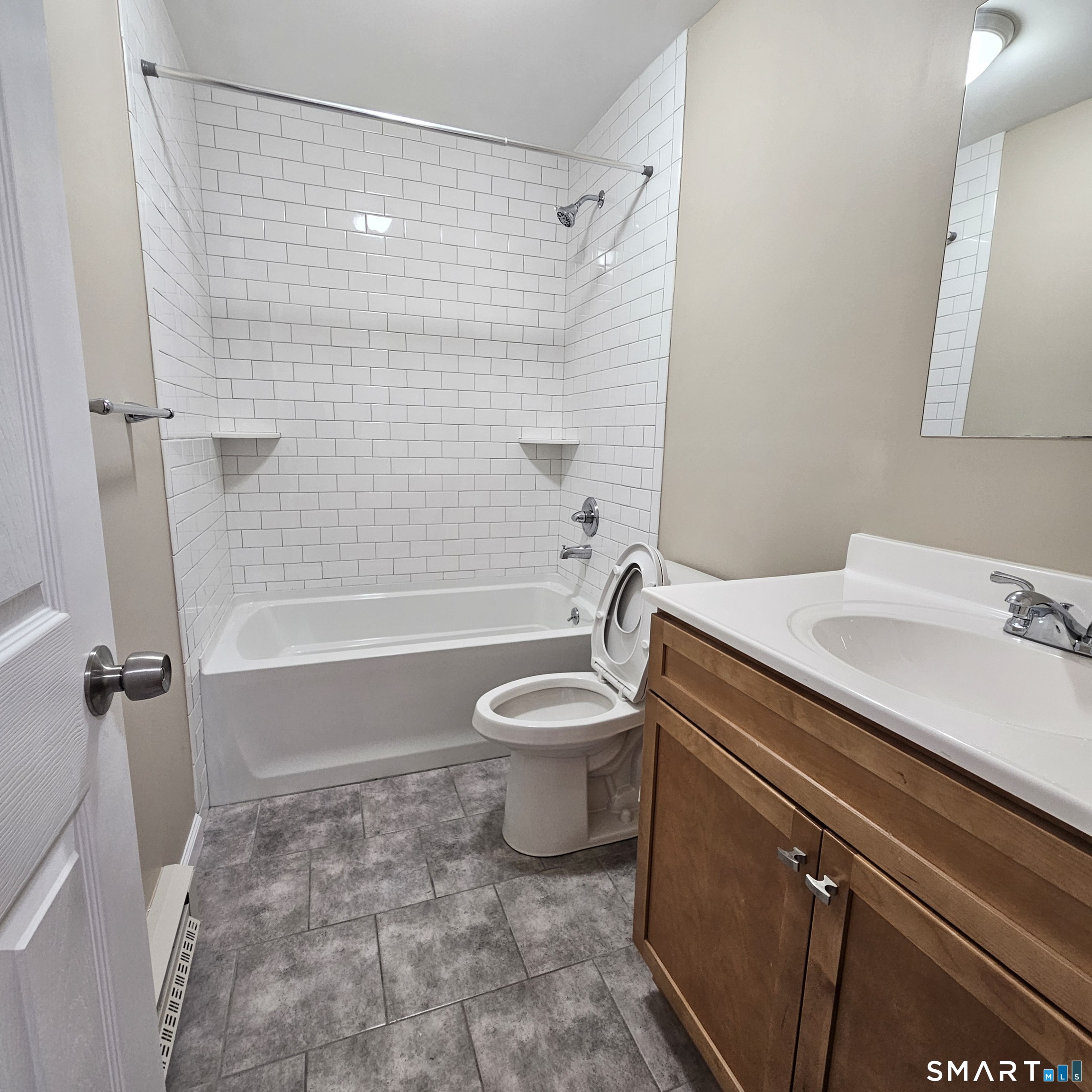 373 Wolcott Street Bristol, CT 06010 - Photo 4 of 23 a bathroom with a granite countertop sink toilet a shower and bathtub