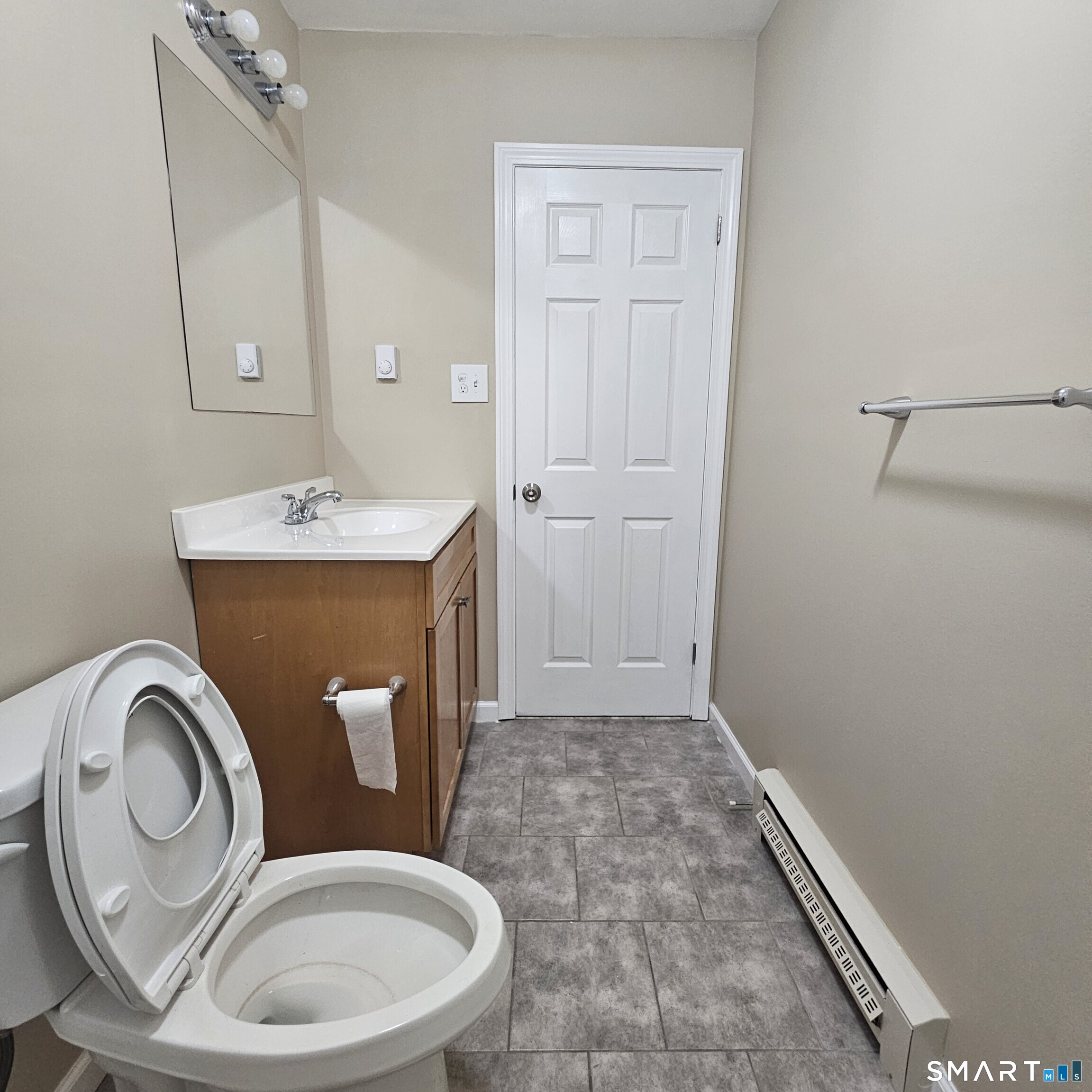 373 Wolcott Street Bristol, CT 06010 - Photo 6 of 23 a bathroom with a toilet a sink and mirror
