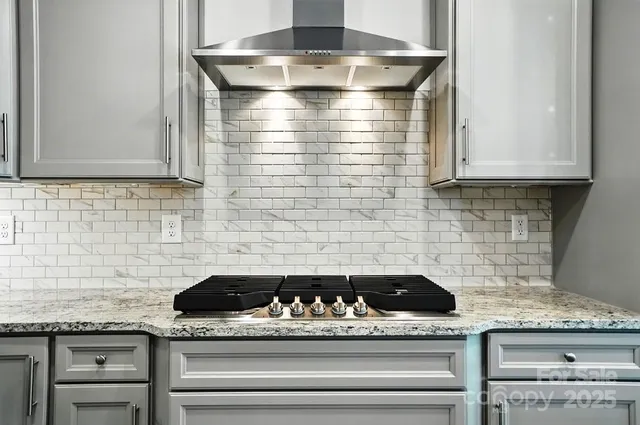 a kitchen with granite countertop cabinets and utility