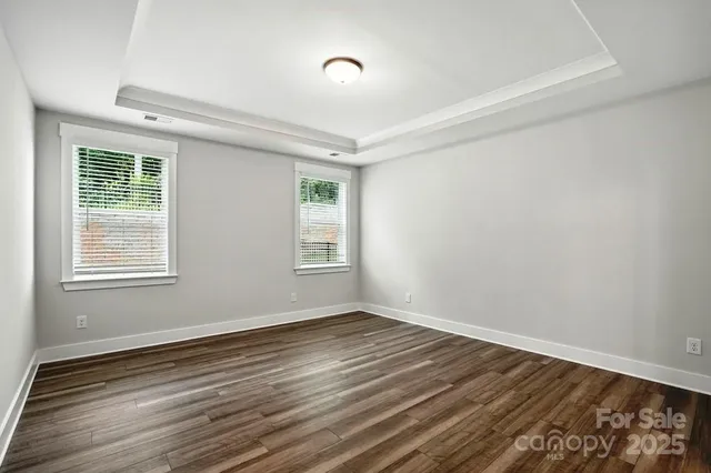 a view of wooden floor and windows in a room