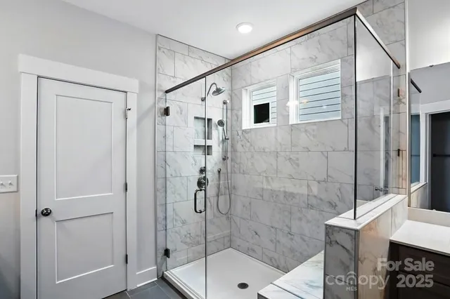 a bathroom with a shower and a sink