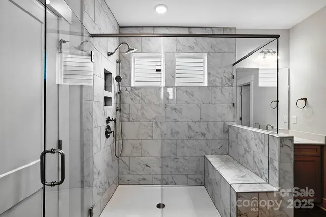 a bathroom with a shower and a sink