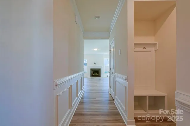 a view of a hallway with wooden floor and staircase