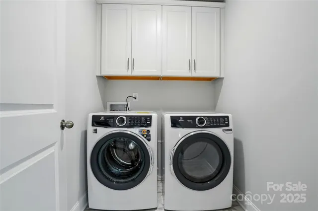 a view of a big room with wooden floor and a bathroom
