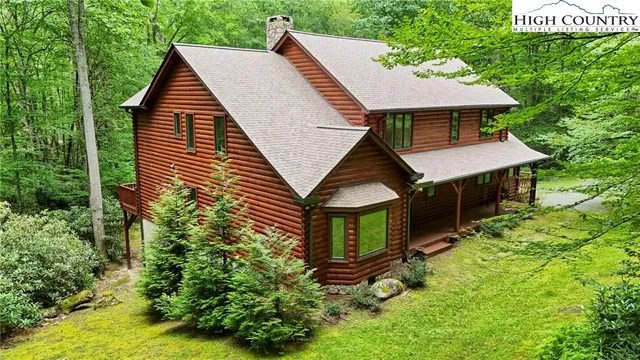 a aerial view of a house next to a yard