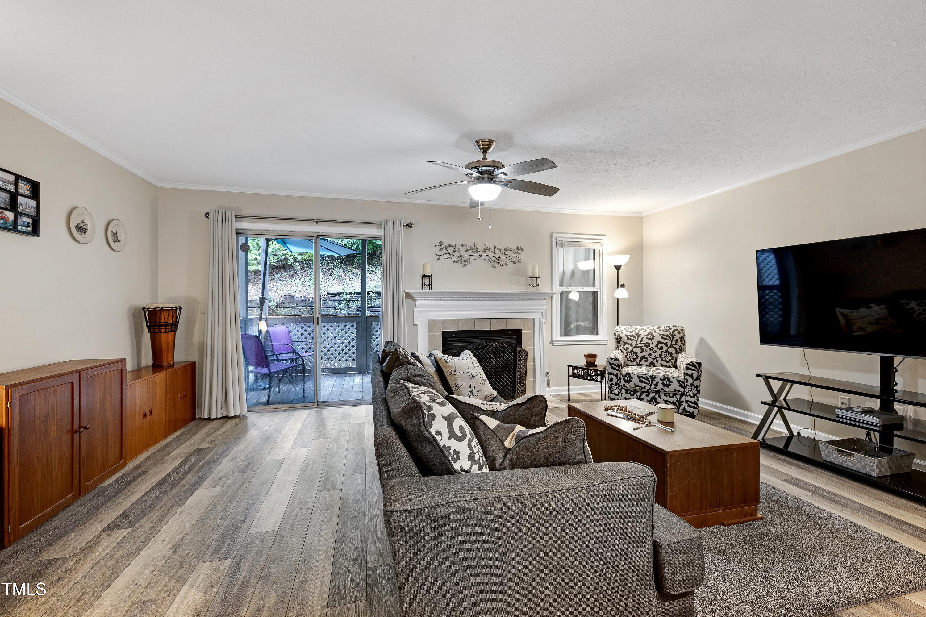 202 Oak Hollow Court Raleigh, NC 27613 - Photo 9 of 44 a living room with furniture and a flat screen tv