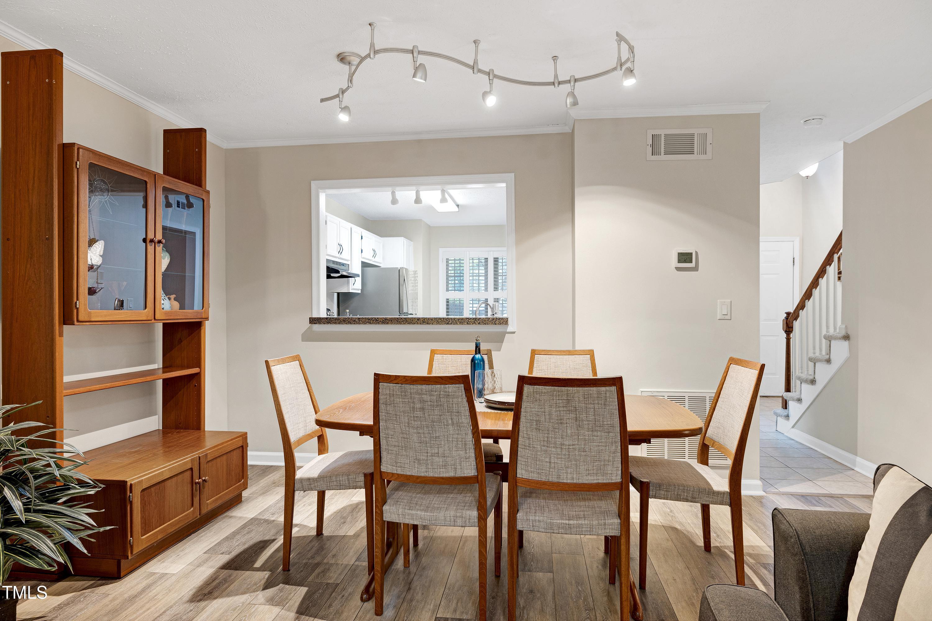 202 Oak Hollow Court Raleigh, NC 27613 - Photo 12 of 44 a dining room with furniture and window