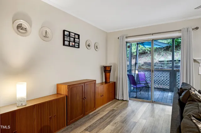 a view of a livingroom with furniture wooden floor and window